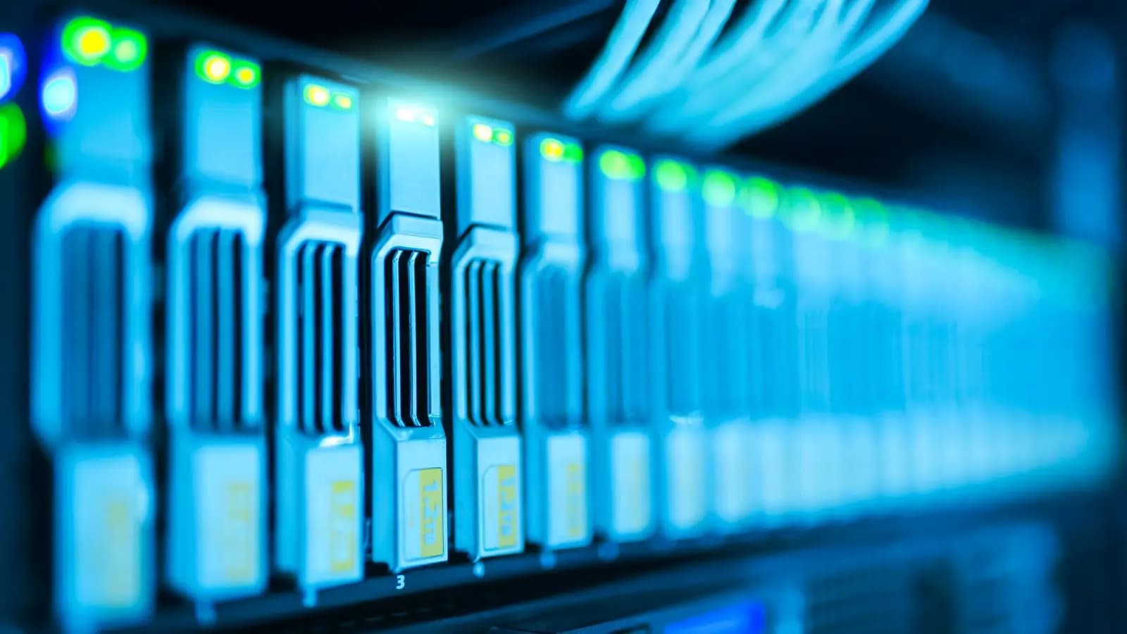 Server rack in a data centre with rows of status lights glowing blue